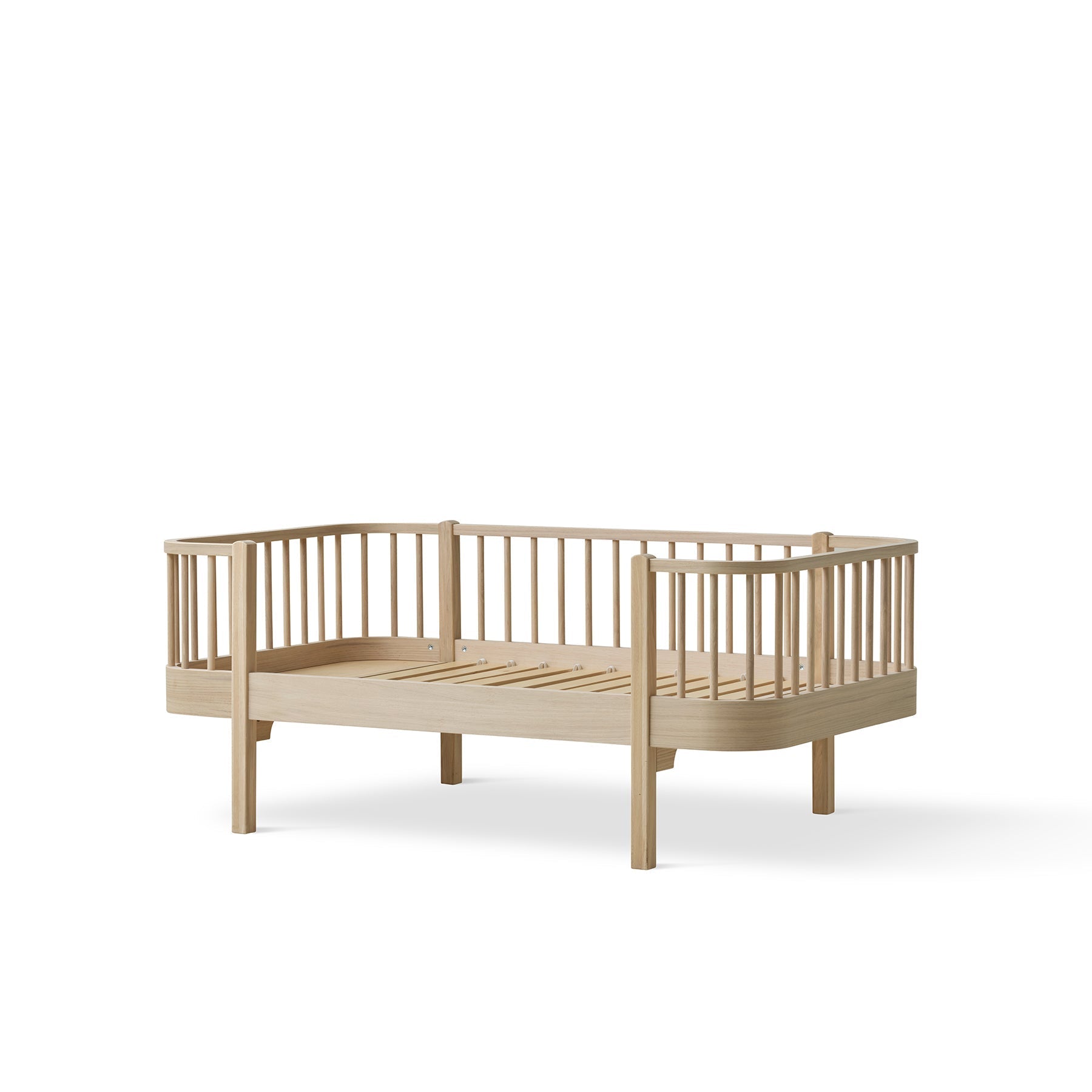 Wooden toddler bed on a white background